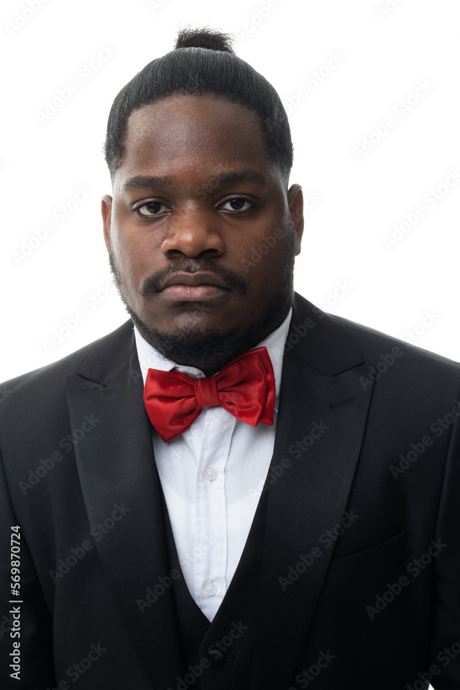 Cool young positive african american man in classic elegant black suit on white background. Portrait of showman or presenter of festive event who smiles at camera. Cool young positive african american man in classic elegant black suit on white background. Portrait of showman or presenter of festive event who smiles at camera.