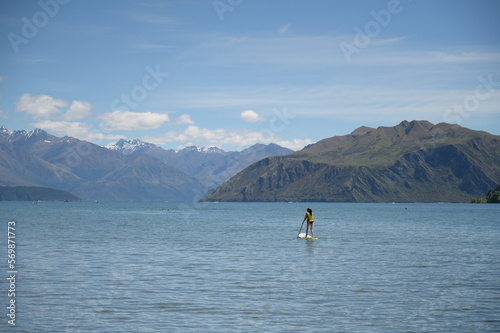 A girl enjoy paddling on the lake