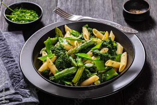 Pasta primavera with green veggies, cheese in bowl photo