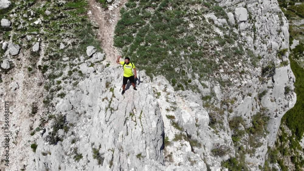 drone rotate around young backpackers climbers at the top of mountains hill in Bovilla lake Mount Dajti