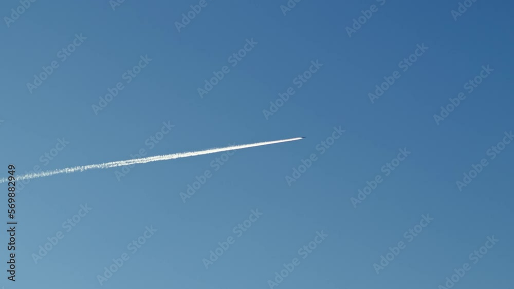 Airplane travel in the blue sky with trails behind it Airplane travel in the blue sky with trails behind it