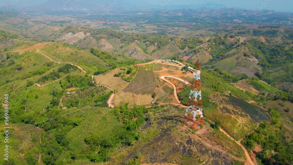 Electrical tower in Thailand with a beautiful green landscape and blue sky.
Electrical tower in Thailand with a beautiful green landscape and blue sky.