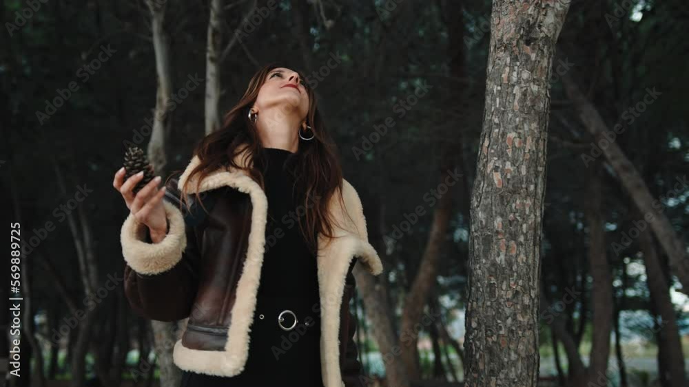 Girl in the pine forest with a brown jacket Girl in the pine forest with a brown jacket