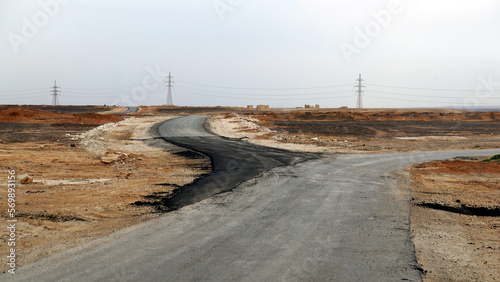 The road to the desert castle Qasr Al-Kharranah in the Eastern Desert in Jordan in the month of January photo