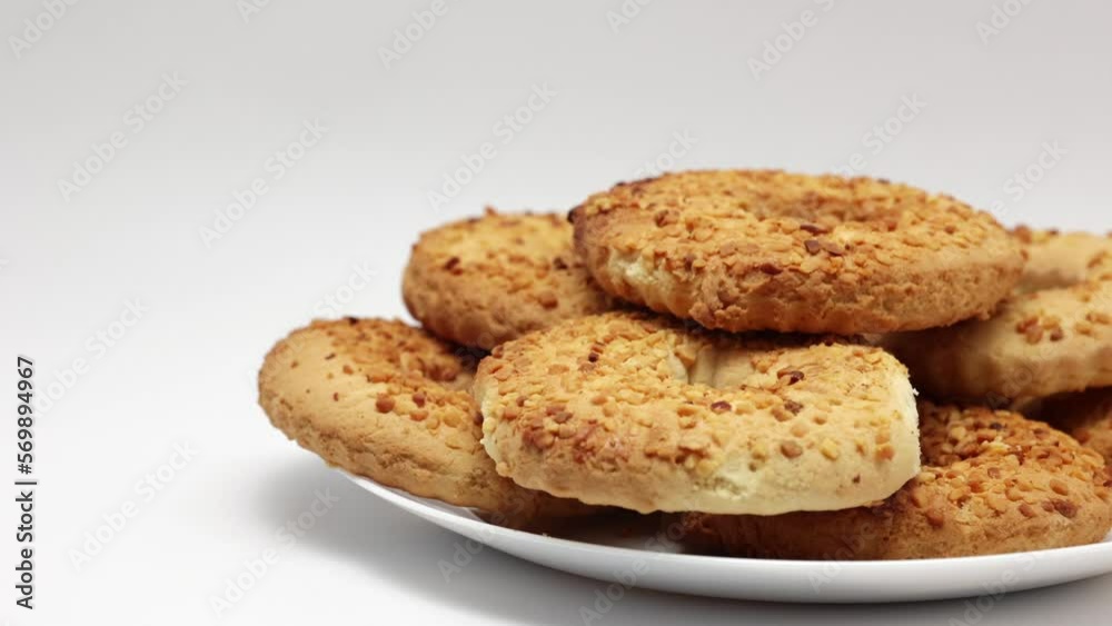 A Ring Of Shortbread Cookies With Peanuts On A White Plate. Dolly Slider Shot. 4k, 60 FPS A Ring Of Shortbread Cookies With Peanuts On A White Plate. Dolly Slider Shot. 4k, 60 FPS