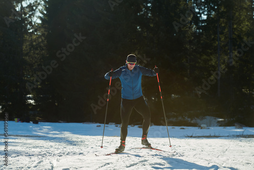 Nordic skiing or Cross-country skiing classic technique practiced by man in a beautiful panoramic trail at morning.Selective focus.