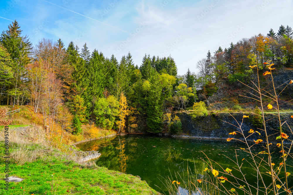 View of the mountain lake Teufel's Tintenfass in Riedenberg landscape at the nature reserve. Basaltsee Tintenfass.
