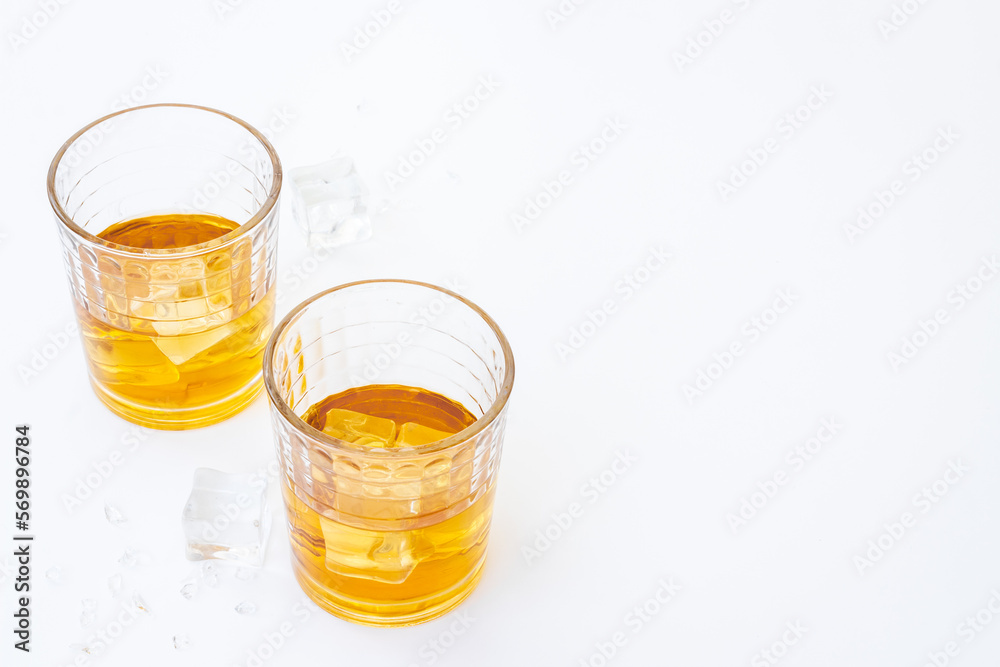 Glass of strong alcoholic drink whiskey with ice. Alcohol background