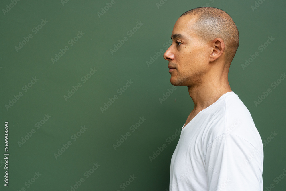 Profile view portrait of handsome bald man wearing t-shirt Profile view portrait of handsome bald man wearing t-shirt
