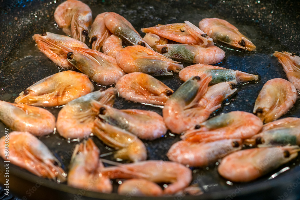 shrimps fried with soy sauce, garlic in oil in frying pan Seafood Traditional Thai food