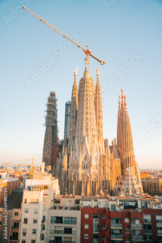 View of Barcelona Eixample residential district and Sagrada Familia Basilica at sunrise or sunset. Catalonia, Spain. Cityscape with typical urban houses © Pavel Kašák