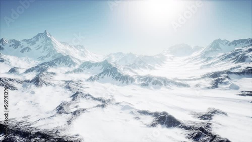 Scenic view on snowy Matterhorn peak in sunny day with blue sky photo