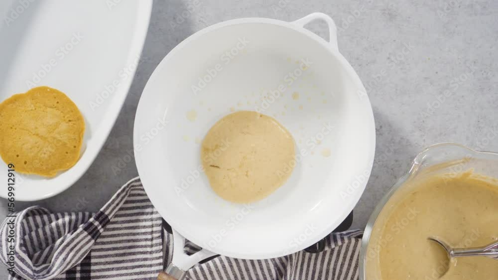 Step by step. Flat lay. Frying pumpkin pancakes batter on a white frying pan. Step by step. Flat lay. Frying pumpkin pancakes batter on a white frying pan.