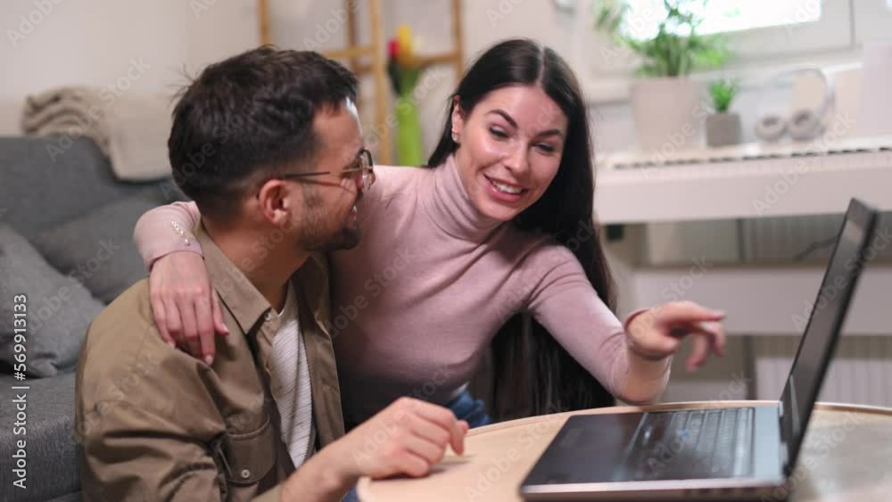 Young couple relaxing on sofa with laptop.Love,happiness,people and fun concept. Young couple relaxing on sofa with laptop.Love,happiness,people and fun concept.