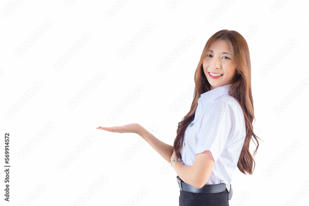 Portrait of an adult Thai student in university student uniform. Asian beautiful girl standing to present something confidently isolated on white background