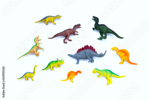 Fototapeta Naklejka Na Ścianę i Meble -  Plastic dinosaur toys on white background. Top view
