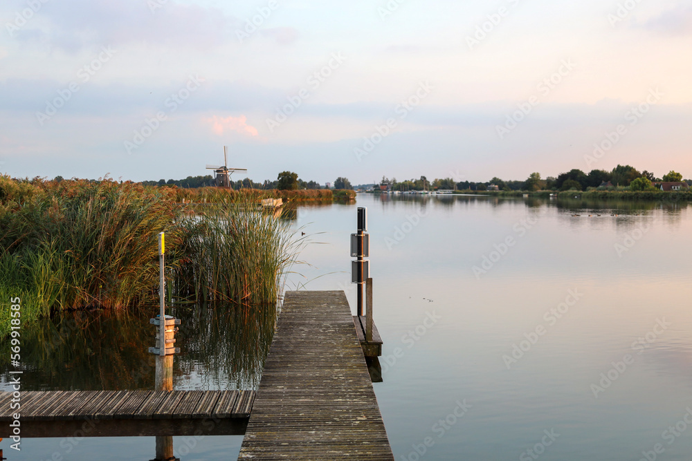 Fototapeta premium Sunset over river Rotte at the Tweemanspolder in Zevenhuizen