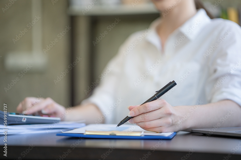Close-up hand businesswomen using a pen for work. Close-up hand businesswomen using a pen for work.