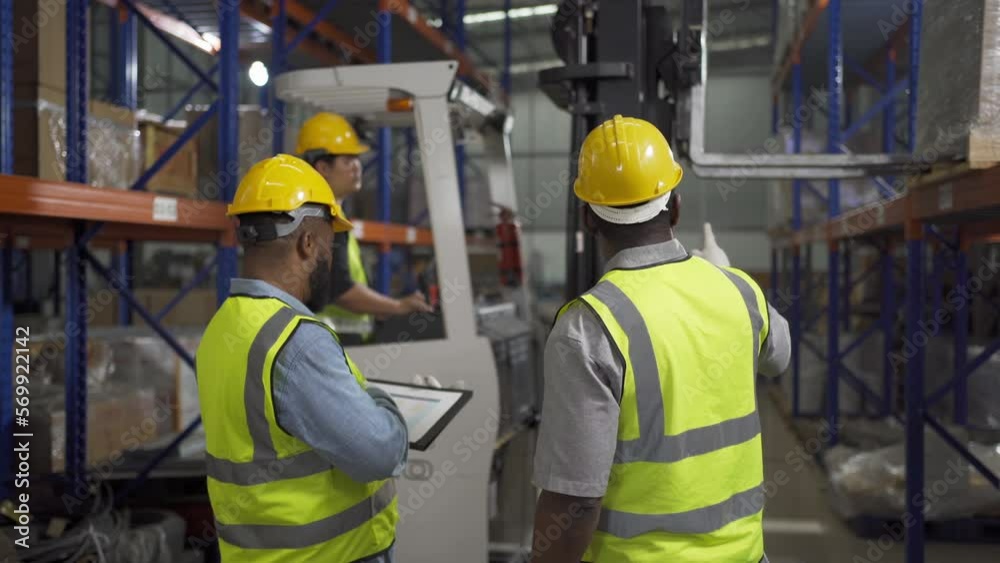 Teamwork of black workers working in large warehouse store industry.Rack of stock storage. Interior of cargo in ecommerce and logistic concept. Depot. People lifestyle. Shipment service for container Teamwork of black workers working in large warehouse store industry.Rack of stock storage. Interior of cargo in ecommerce and logistic concept. Depot. People lifestyle. Shipment service for container