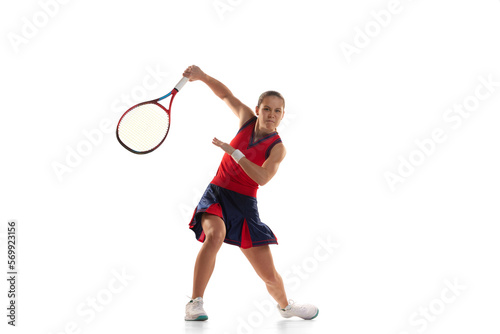 Studio shot of active teen girl, professional tennis player training with tennis racket over white background. Sport, fashion, ad, action, motion, achievement concept © Lustre