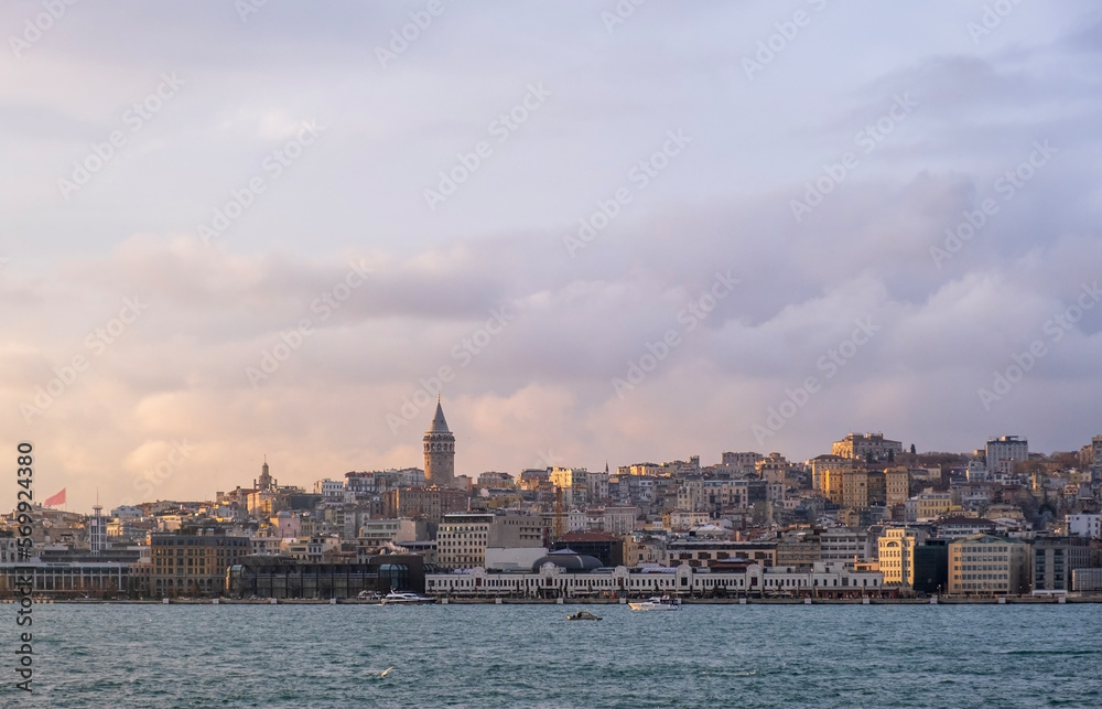 sunset view in istanbul bosphorus. Red sunset in Istanbul. Historical Galata tower and istanbul silhouette. View of the Galata Tower in Beyoglu district at sunset along the Golden Horn in Istanbul.

