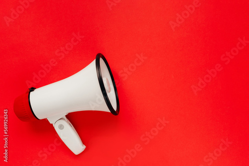 White megaphone on red background. Alarm and announcement