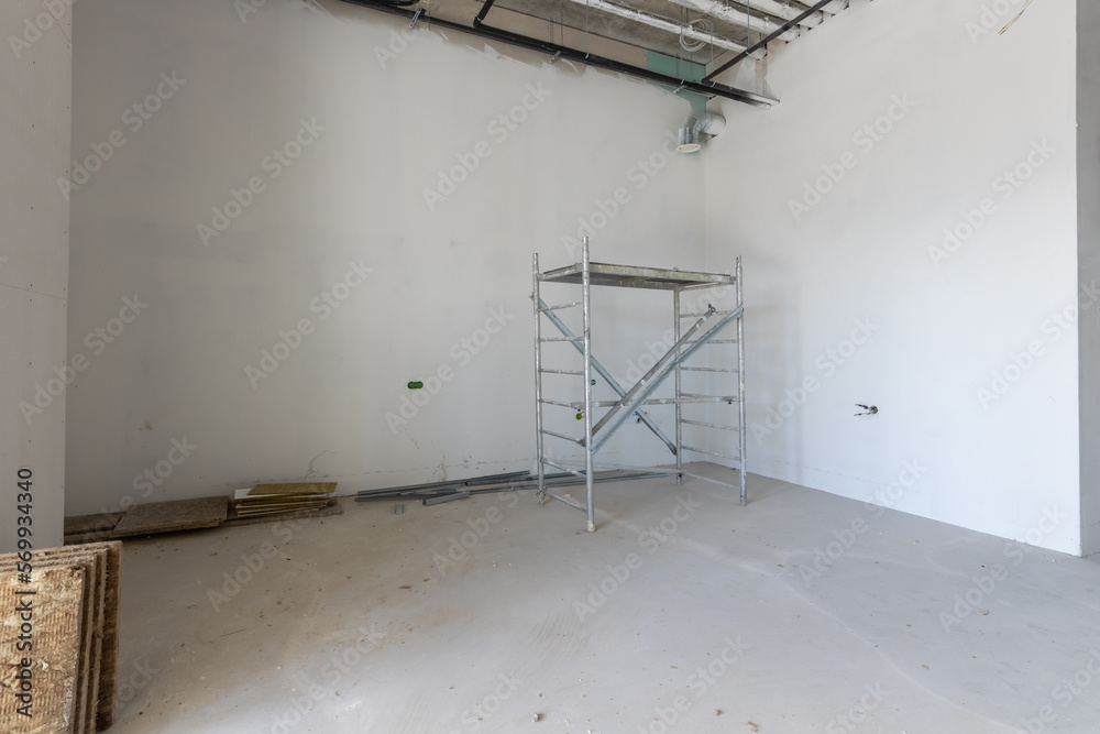 Room is under renovation or under construction. Scaffolding in the office under construction. Room is under renovation or under construction. Scaffolding in the office under construction.