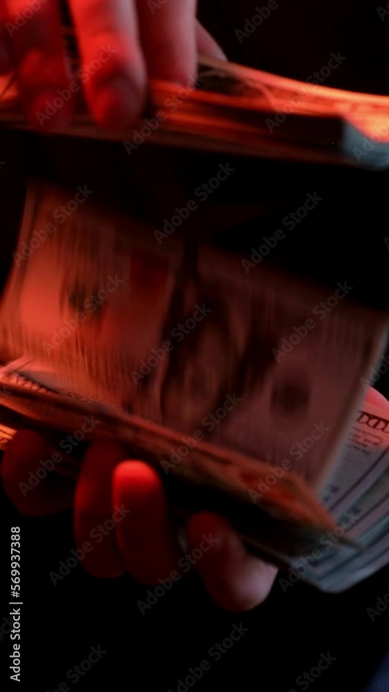 close-up of male hands counting a stack of hundred-dollar US banknotes. a businessman is counting cash. the concept of investment, money exchange, bribes or corruption. selective focus. close-up of male hands counting a stack of hundred-dollar US banknotes. a businessman is counting cash. the concept of investment, money exchange, bribes or corruption. selective focus.