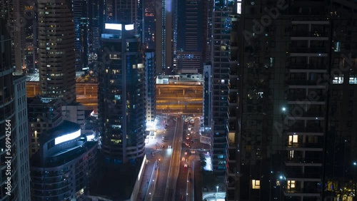Timelapse, 4k, aerial view of the urban landscape of a modern night city, people move along the street, cars move along the road