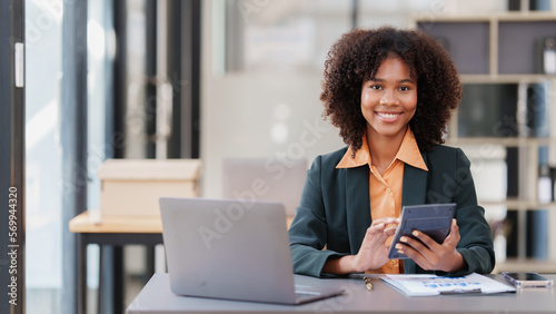 Obraz na płótnie Accountant black woman working on laptop and do document, tax, exchange, account