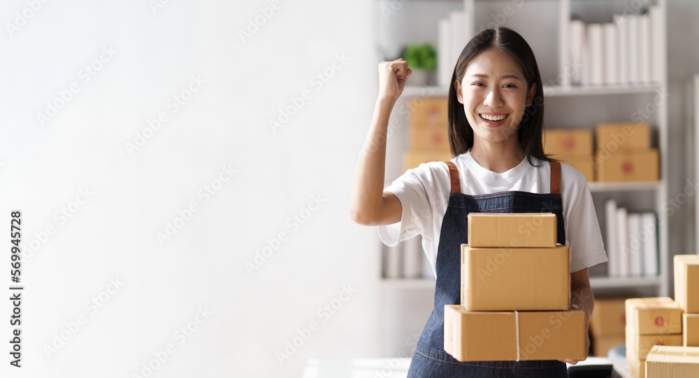 Young asian woman startup small business freelance holding parcel box, Online marketing packing box delivery concept.. Young asian woman startup small business freelance holding parcel box, Online marketing packing box delivery concept..