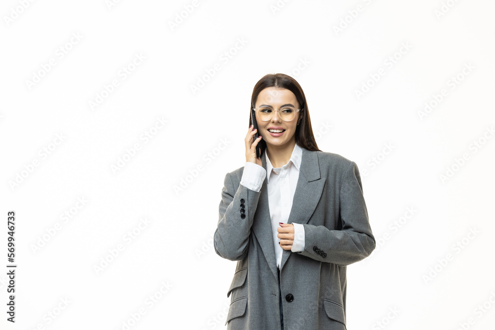 Smiling young business woman talking on mobile phone isolated over white background Smiling young business woman talking on mobile phone isolated over white background
