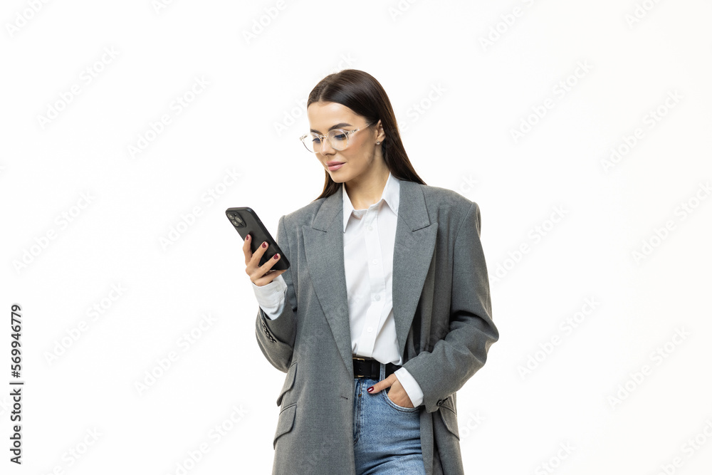 Portrait of a happy a businesswoman holding mobile phone and looking away isolated over white background Portrait of a happy a businesswoman holding mobile phone and looking away isolated over white background