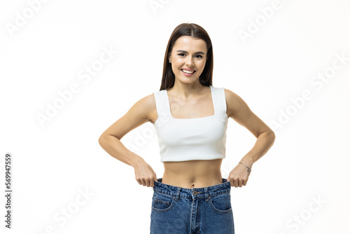 beautiful young woman with big jeans, isolated on white background