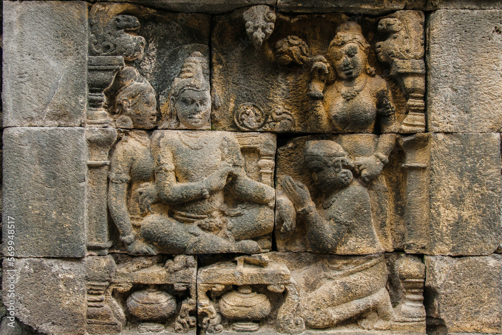 A fragment of the Borobudur Temple wall carvings with Buddha. Central Java, Indonesia. A fragment of the Borobudur Temple wall carvings with Buddha. Central Java, Indonesia.