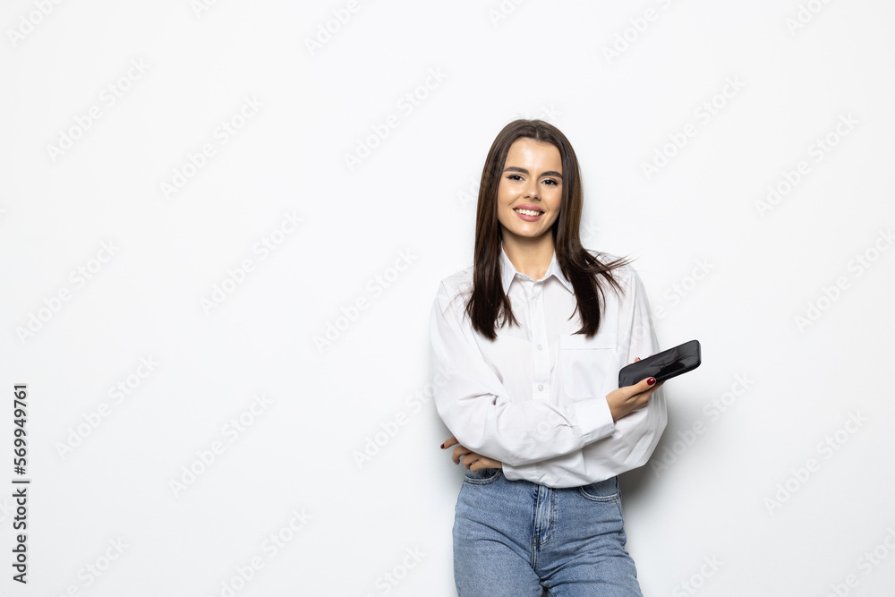 Portrait of a smiling woman holding smartphone over white background Portrait of a smiling woman holding smartphone over white background