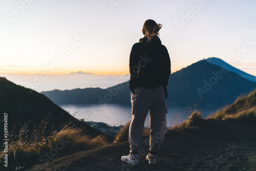 Anonymous female hiker on mountain peak