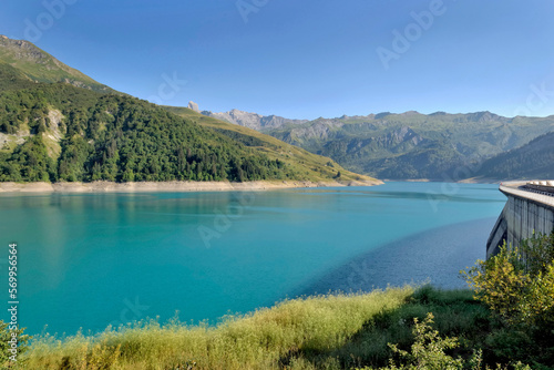 the roselend dam with turquoise water in a mountainous landscape in France