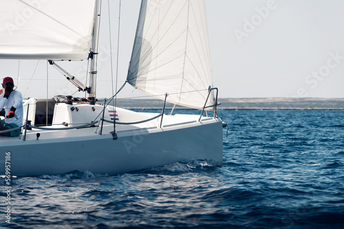 Side view of a sailing yacht during regatta in open sea