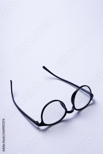 Sunglasses with transparent lenses and upside down on a white background.