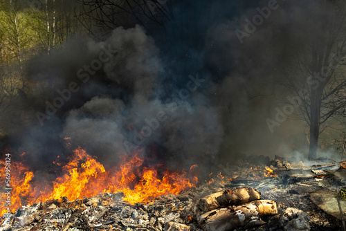 Fire in landfill. Fire and smoke. Burning garbage. © Олег Копьёв