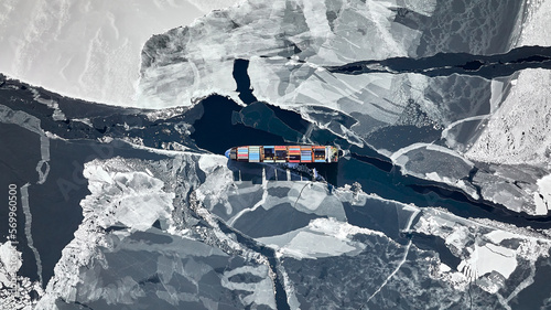 A container ship passes through thick ice in the north