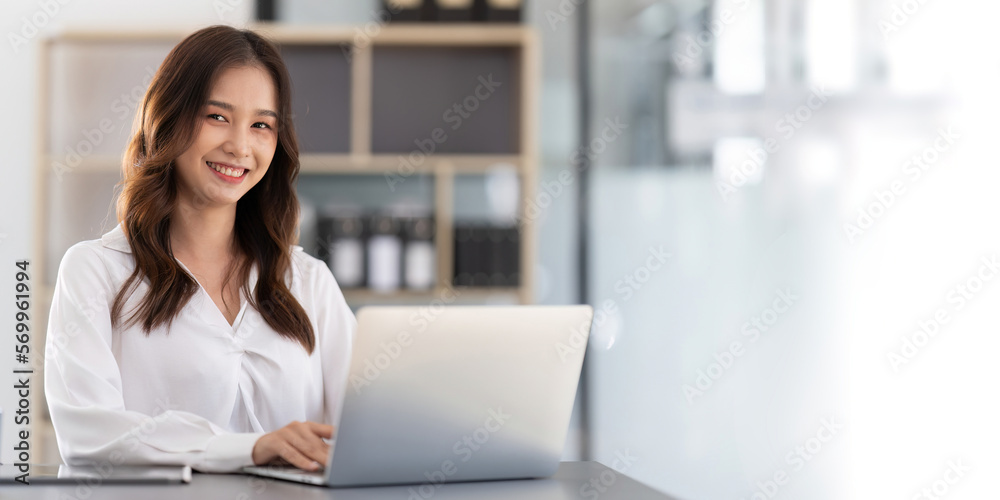 Young businesswoman working on laptop in office Young businesswoman working on laptop in office