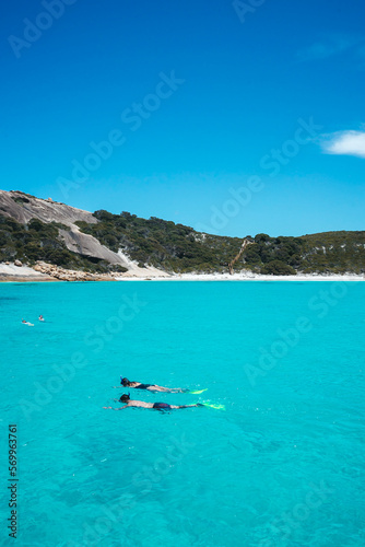 Vertical photo of a couple snorkelling in the aqua blue water of Blue Haven in Esperance, Western Australia