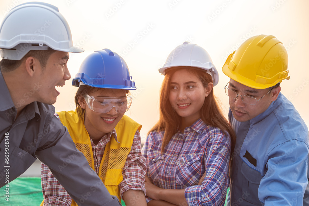 Engineers coworker discuss construction projects in workplace construction site. group of technician architect planning with blueprint and construction tools Engineers coworker discuss construction projects in workplace construction site. group of technician architect planning with blueprint and construction tools