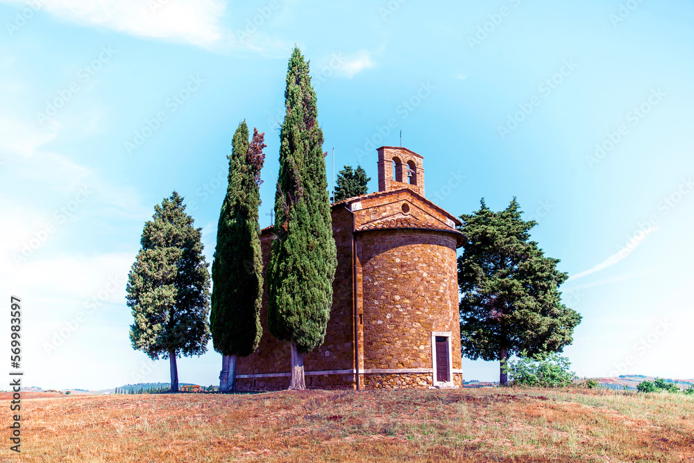Magic landscape with chapel of Madonna di Vitaleta on a sunny day in San Quirico d'Orcia (Val d'Orcia) in Tuscany, Italy. Excellent tourist places.