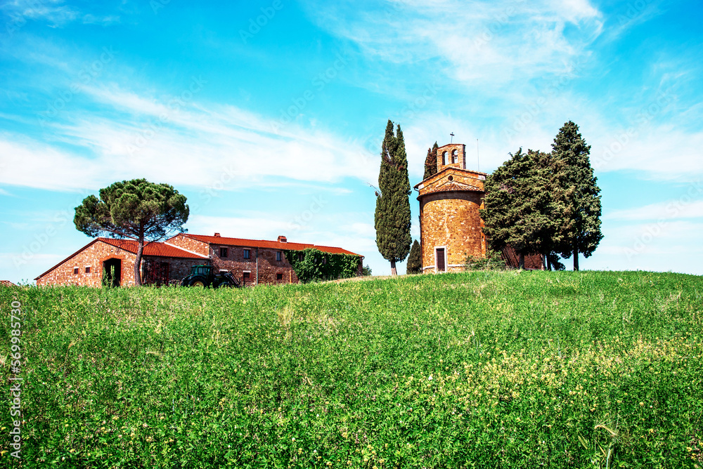 charming landscape with chapel of Madonna di Vitaleta near rape fiald on a sunny day in San Quirico d'Orcia (Val d'Orcia) in Tuscany, Italy. Excellent tourist places.