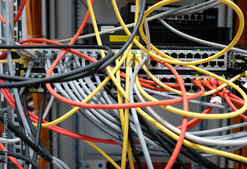 Network technology - multiple colorful cables in an IT and server room