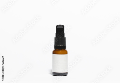 Mockup of amber colored glass bottle of cosmetic and facial skincare and skincare products, on a white background