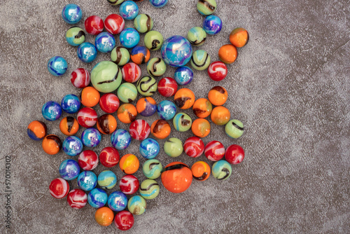 Glass colored marble balls , glass balls isolated on gray background . Children's play equipment.